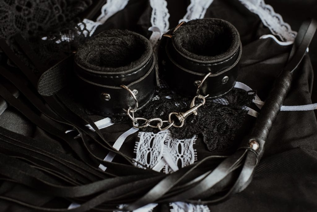 Black lace and leather cuffs, the textures of a feminisation session