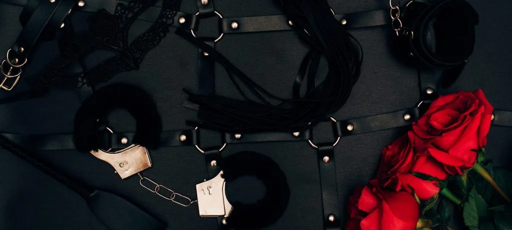 Leather cuffs, harness and a red rose: bondage and restraint with a London dominatrix