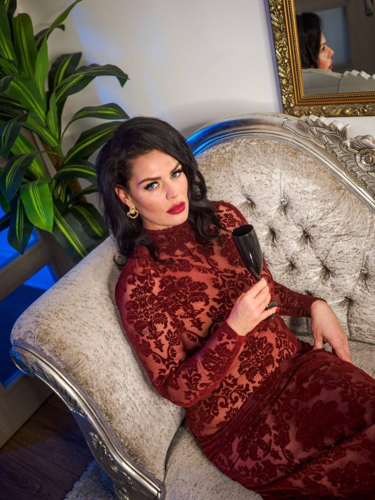 Mistress Charlotte in a red lace dress, feminisation and sissy training in London