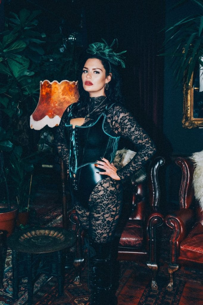 Mistress Charlotte in black lace and a leather corset, chastity mistress in London