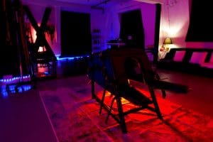 The open-plan dungeon of the BDSM penthouse at Tower Bridge in red and violet light